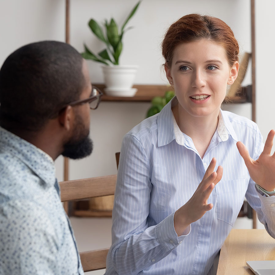 Woman and man discuss a commercial building purchase Woman and man discuss a commercial building purchase